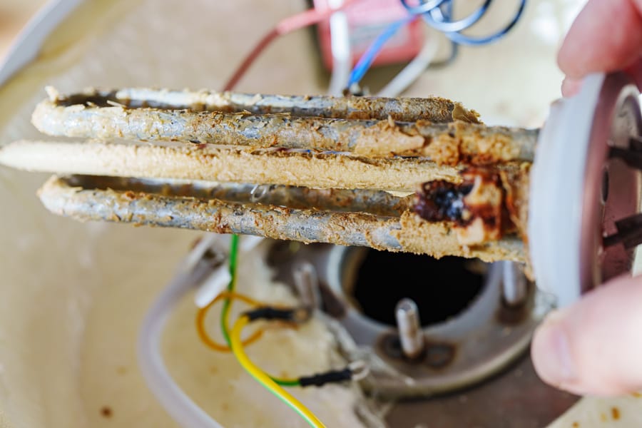 Limescale on the heating element of the water heater, scale is formed due to hot and hard water, rust that gets into the boiler along with it.