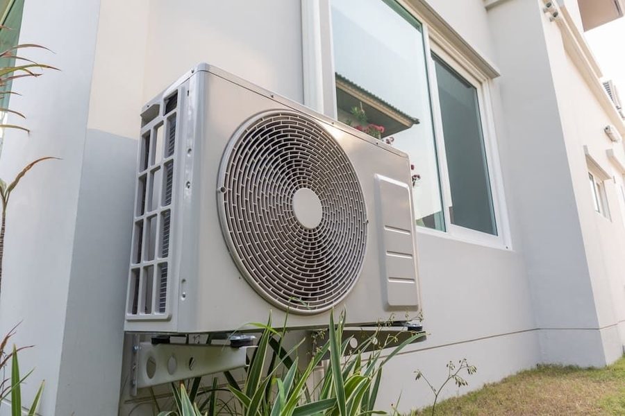 Heat pump on the side of a residential home